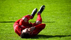 Soccer player laying on field in pain